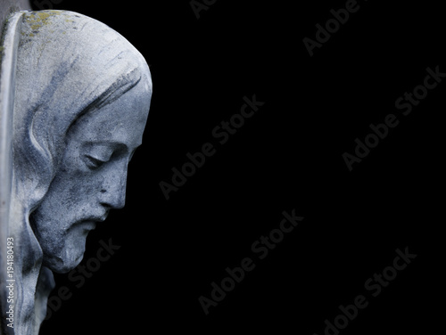 An ancient statue of Jesus Christ in profile (religion, faith, death, suffering, immortality, God concept)