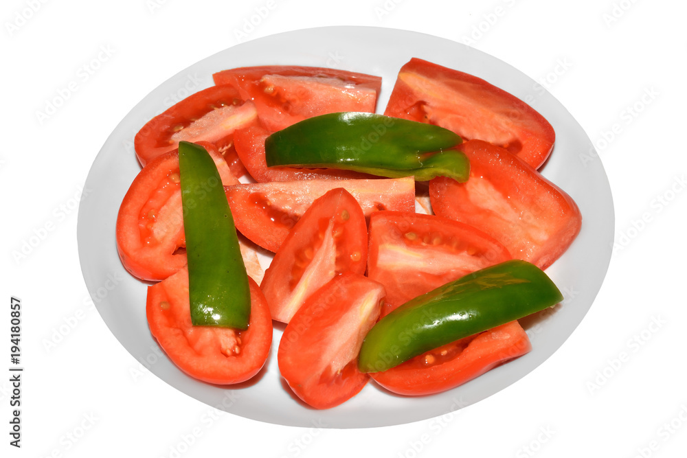 Slices of tomatoes and green pepper on plate isolated on white background Slices of tomatoes and green pepper on plate isolated on white background