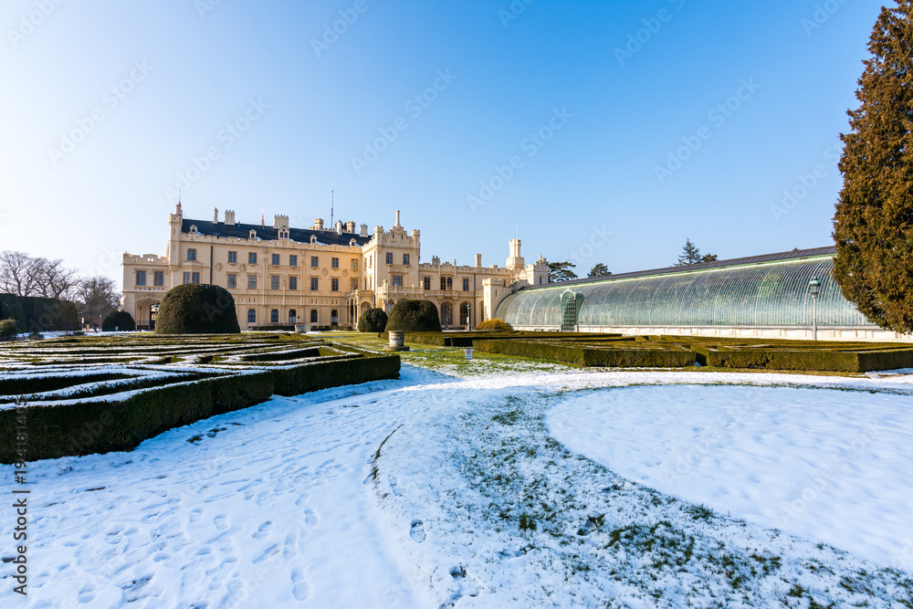 Lednice castle and greenhouse, snow and winter. Blue sky