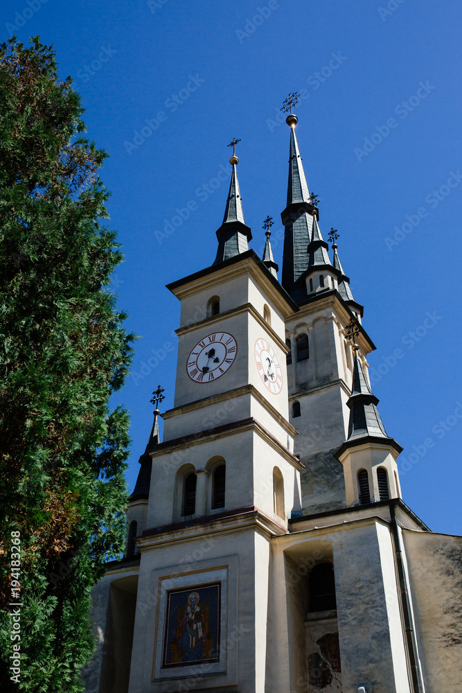 Sf. Nicolae (St. Nicholas) Orthodox Church exterior., Brasov, Transylvania, Romania. Famous tourist attraction travel destination vertical postcard.