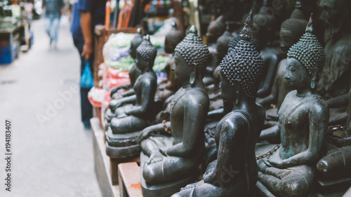 old Buddha statues on the local market close-up. Buddha as a symbol of Buddhism in Thailand and Asia. Portrait of a buddha in statue format on the local market