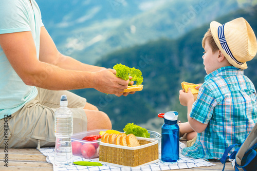 Family on a picnic in the mountains photo