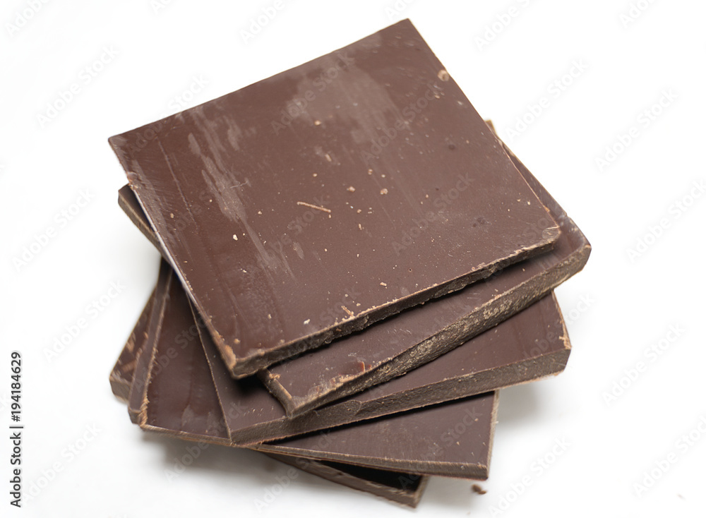 Pieces of dark chocolate on white background. Macro Pieces of dark chocolate on white background. Macro