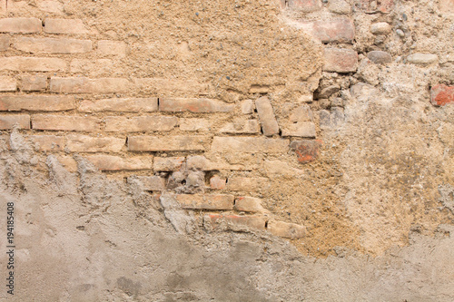 Old brown and ocher brick wall destroyed useful background or texture
