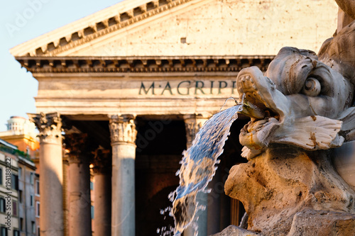 Fountain and the ancient roman Pantheon in Rome at sunset