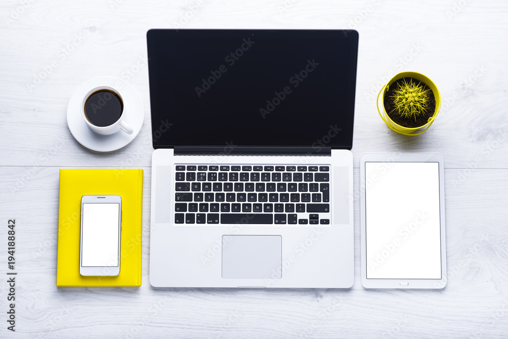 Workplace with office tools and gadgets. Cup of coffee on a table ...
