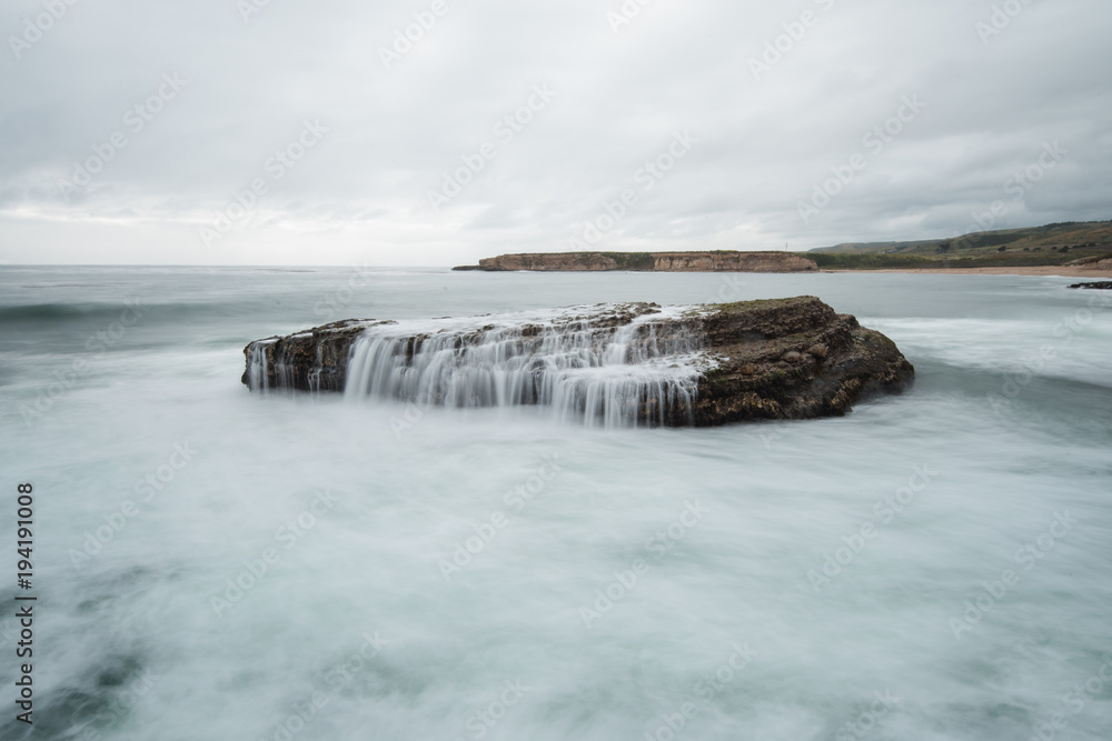 A sea stack in the Pacific Ocean takes on a huge wave A sea stack in the Pacific Ocean takes on a huge wave