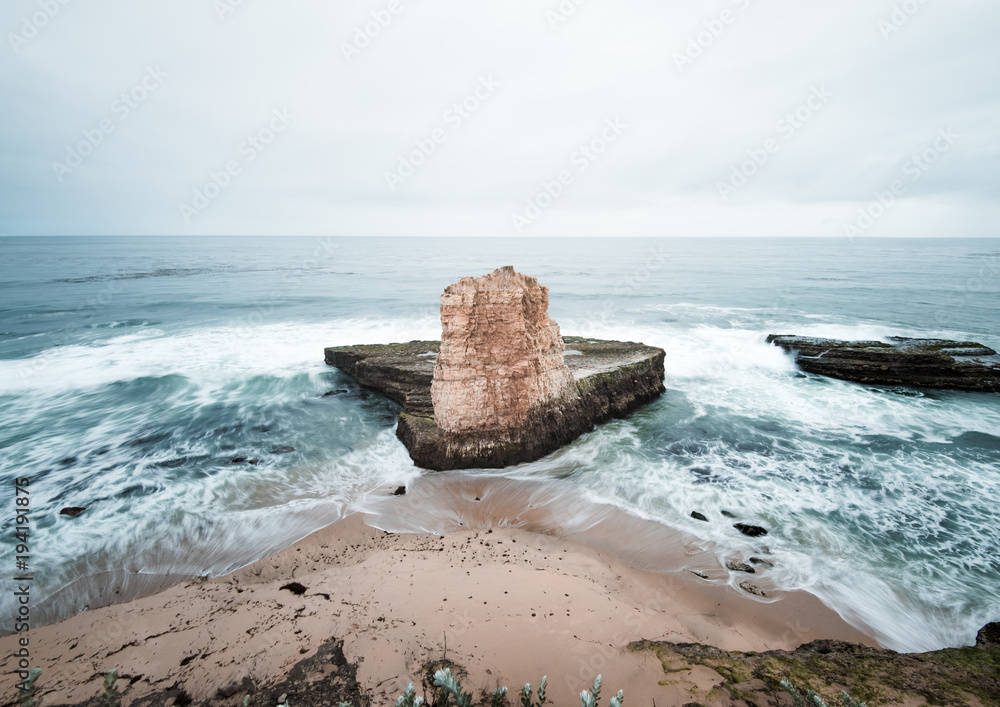 A sea stack in four mile beach near Santa Cruz takes a pounding of