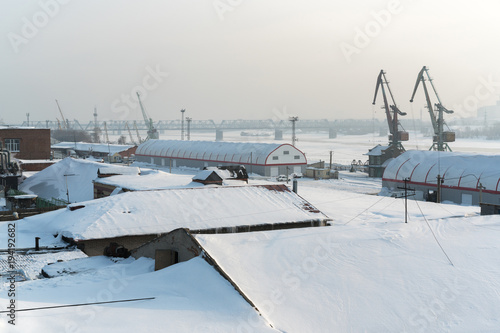 Fotografering river docks in the industrial area of the city in winter