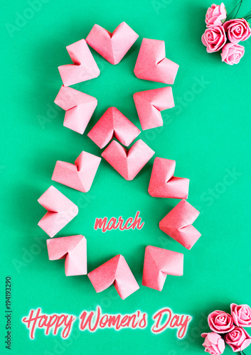 Happy International Women’s Day celebrate on March 8, congratulatory CARD. rose-color paper hearts shape figure eight 8 on white background 