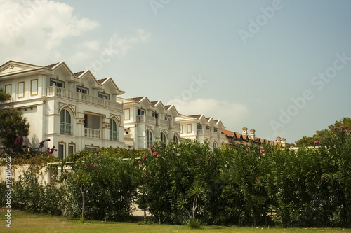 House among green bushes on the beach