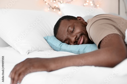 African American man sleeping in bed