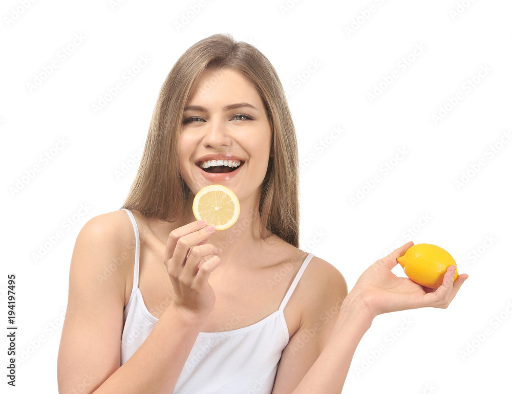 Beautiful young woman with ripe lemon and slice on white background Beautiful young woman with ripe lemon and slice on white background