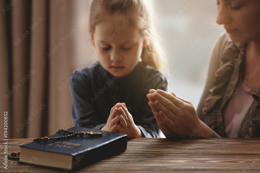 Religious Christian girl praying with her mother indoors Stock Photo ...