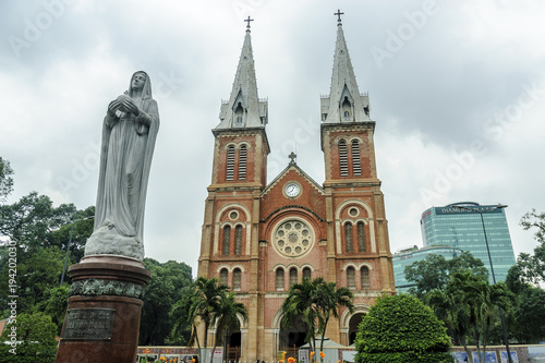 front of the colonial catholic cathedral in city Ho Chi Minh, Vietnam.