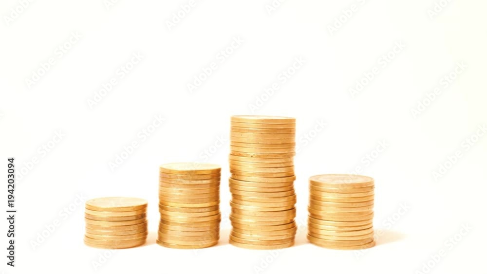 Time lapse of raising and decreasing stacks of coins against white background Time lapse of raising and decreasing stacks of coins against white background