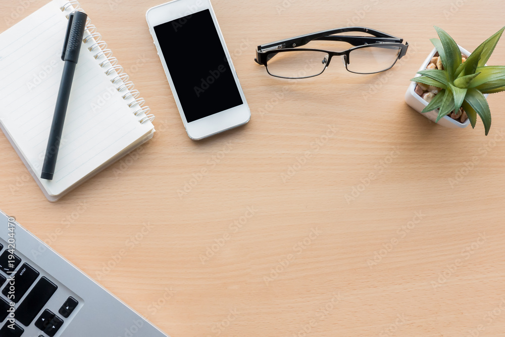Wood office desk table with laptop,smart phone,notebook and pen, Top view with copy space, flat lay. Wood office desk table with laptop,smart phone,notebook and pen, Top view with copy space, flat lay.