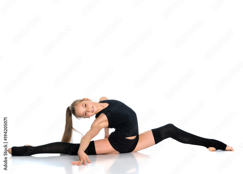 Girl gymnast perform the twine exercise. Girl gymnast perform the twine exercise.