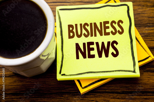 Handwritten text showing Business News. Business concept for Modern Online News written on sticky note paper on the wooden wood background with coffee cup