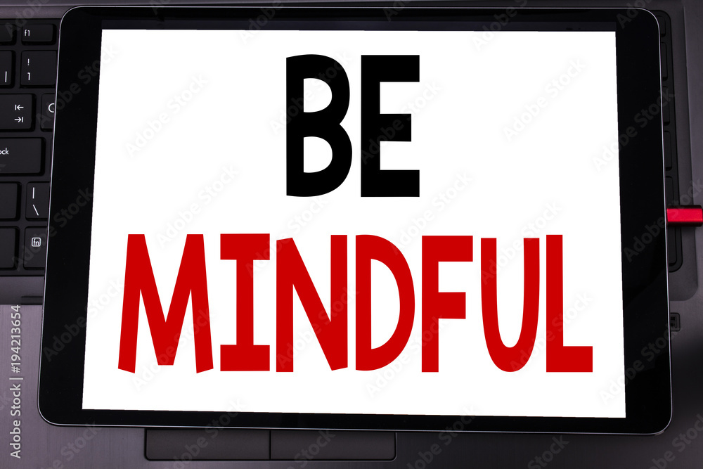 Conceptual hand writing text caption inspiration showing Be Mindful. Business concept for Mindfulness Healthy Spirit written on tablet laptop on the black keyboard background.