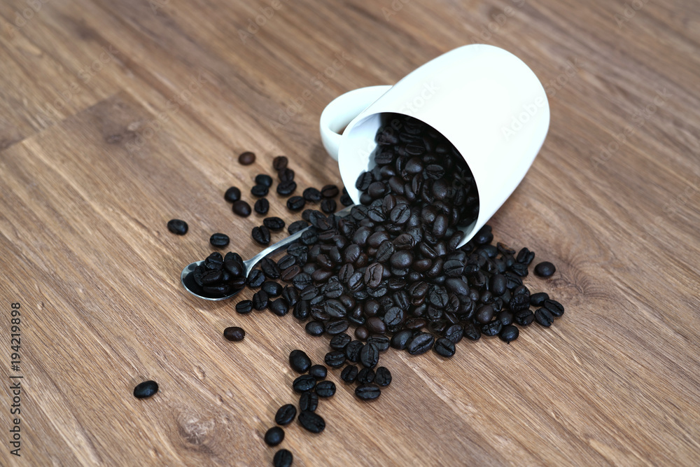 Coffee Bean in Cup on the Wooden floor Coffee Bean in Cup on the Wooden floor
