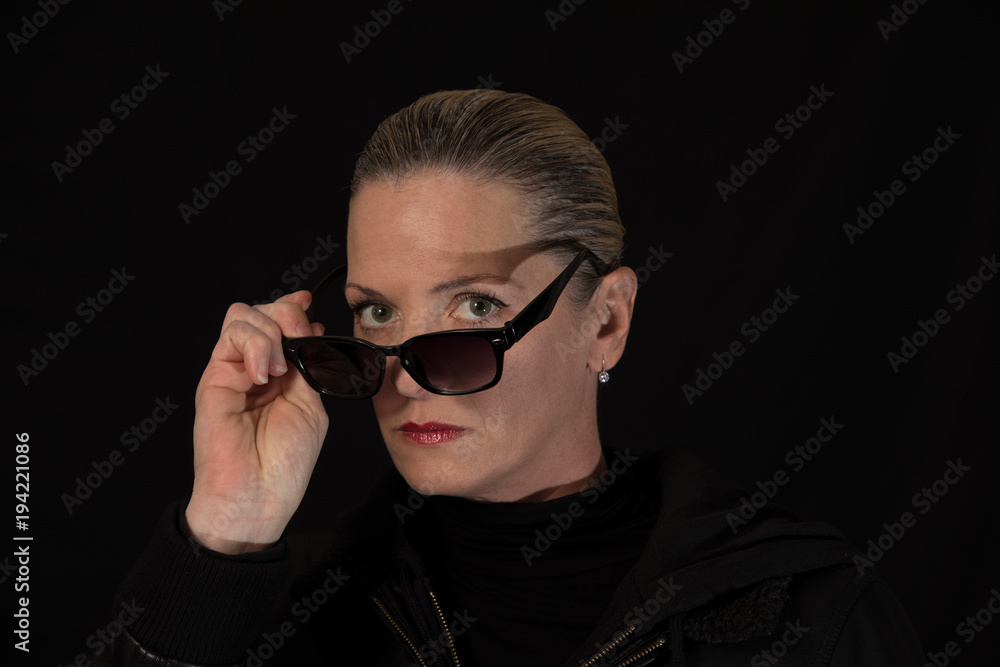 woman with sunglasses is staring at you and not amused woman with sunglasses is staring at you and not amused