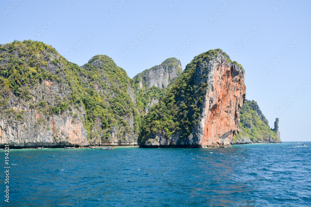 The island of Phi Phi.Island view from a boat on the sea background.Thailand The island of Phi Phi.Island view from a boat on the sea background.Thailand