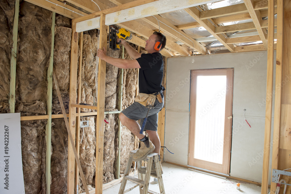 Fotografie attractive and confident constructor carpenter or builder man working wood with