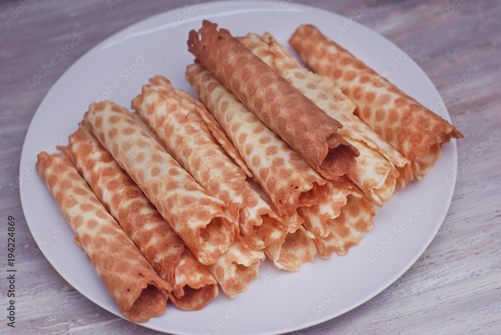 Waffle Tobes or Rolls. Homemade Dessert. White Plate. top view. Toned. Waffle Tobes or Rolls. Homemade Dessert. White Plate. top view. Toned.