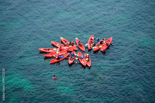 Group of Kayaks in formation in the ocean
