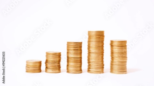 Time lapse of raising and decreasing stacks of coins against white background