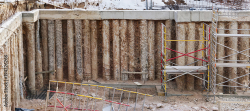 The pit of the new building under construction in the city is fortified with concrete piles photo