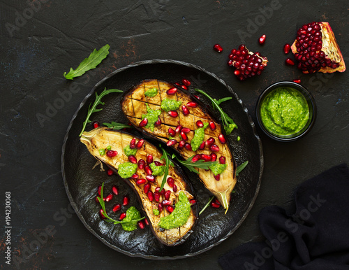 Baked grilled aubergines with pesto and pomegranate sauce.