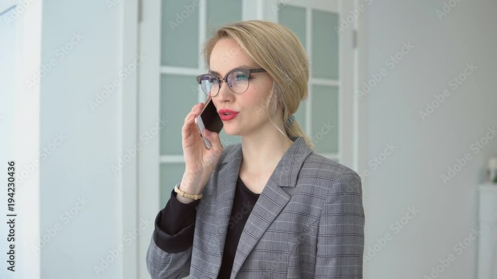 Business young beautiful woman talking on the phone. Business young beautiful woman talking on the phone.