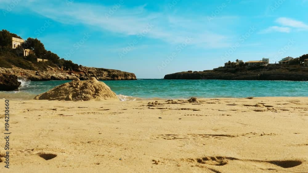 View of the sandy beach near the turquoise sea between the rocks. Europe. View of the sandy beach near the turquoise sea between the rocks. Europe.