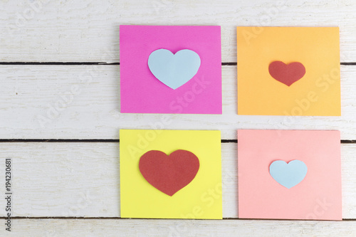 paper sticky notes with heart shaped paper cut outs on wood