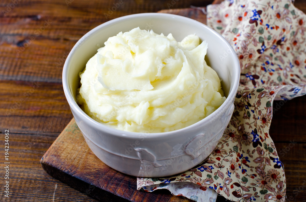 Mashed potatoes in a bowl on a wooden table Mashed potatoes in a bowl on a wooden table