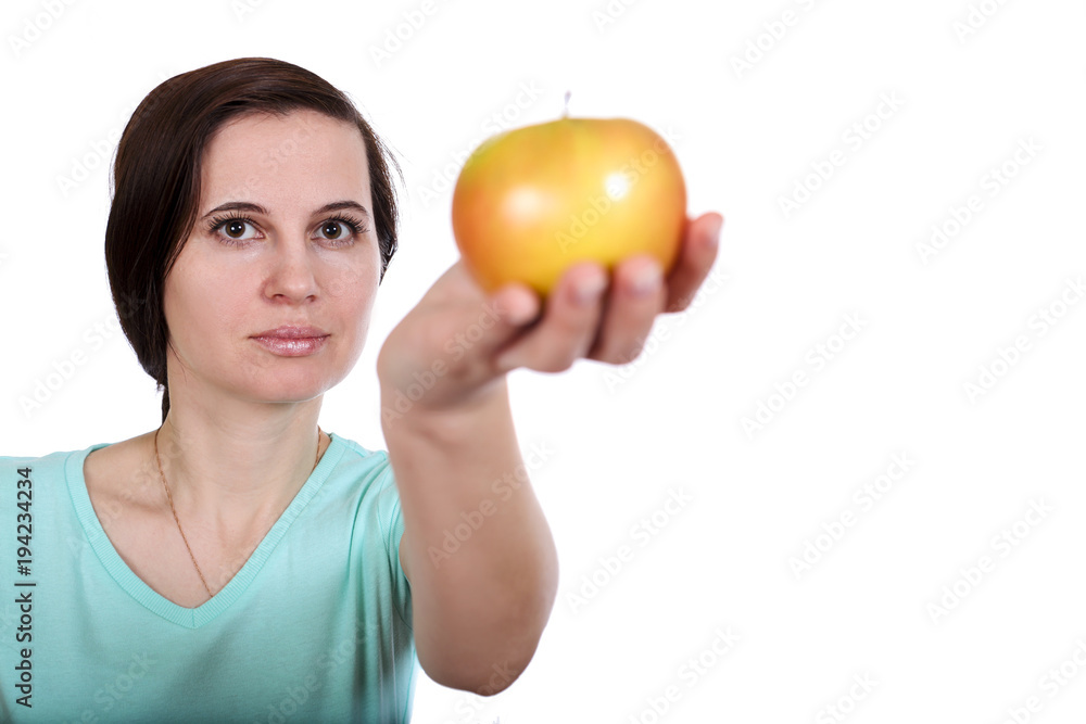The woman in a t-shirt holds apple in hand The woman in a t-shirt holds apple in hand