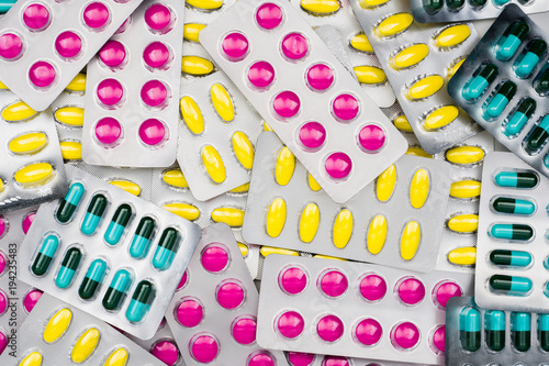 Top view of colorful pile of pills in blister packs. Drug use with reasonable concept. Global healthcare wallpaper.