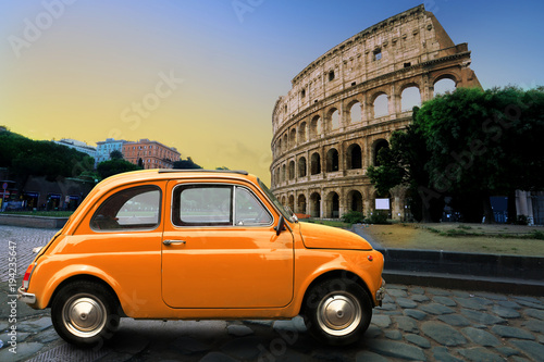 Retro car on background of Colosseum in Rome Italy photo