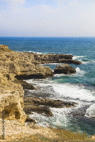 The sea landscape of Cape Tarkhankut, Crimea peninsula. Blue water and yellow rocks. Bright sunny background or wallpaper
