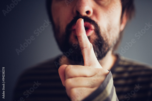 Man saying hush or be quiet photo
