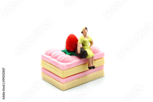 Miniature people : woman sitting with dessert,fun and food concept.