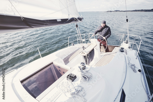 Aged man on sailboat