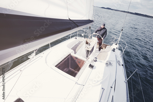 Aged man on sailboat © Sergey Furtaev