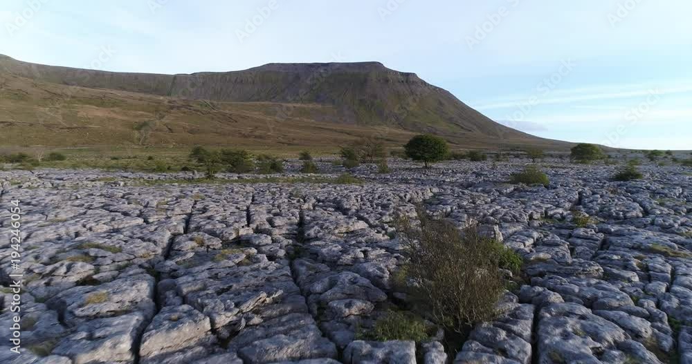 Aerial shot of a flight over limestone pavement, Ingleborough mountain in the background. Aerial shot of a flight over limestone pavement, Ingleborough mountain in the background.
