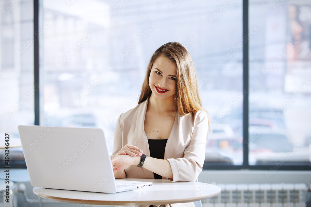 Businesswoman in the office sitting and working with laptop Businesswoman in the office sitting and working with laptop