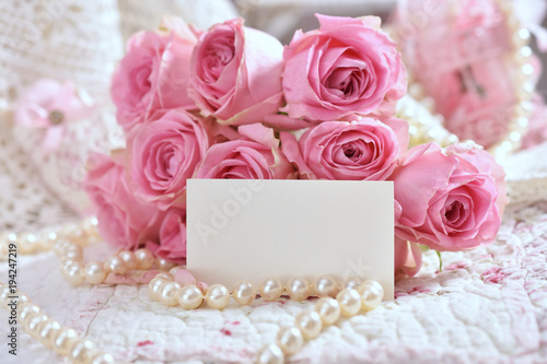 bunch of pink roses with blank card for greeting text