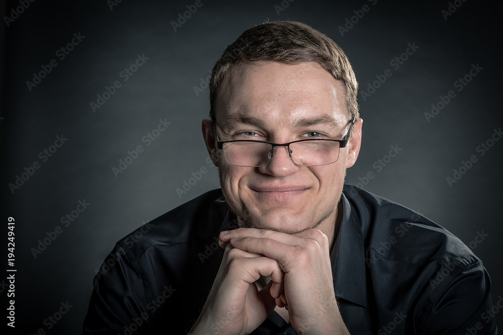 Portrait of handsome man in glasses on dark background Portrait of handsome man in glasses on dark background