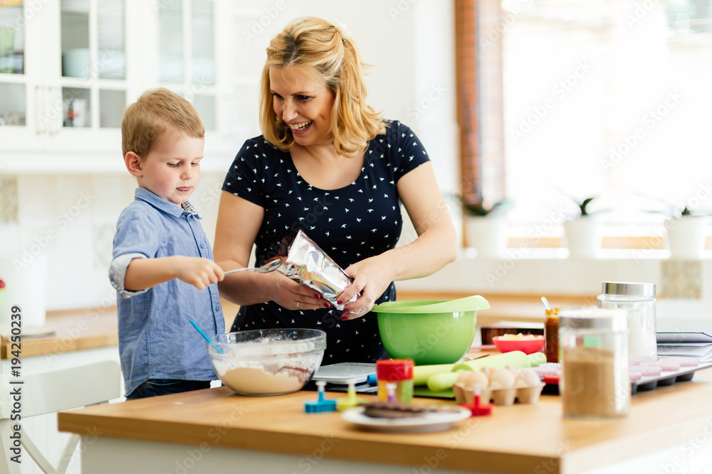 Child helping mother bake cookies Child helping mother bake cookies